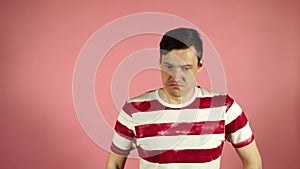 Man standing isolated on pink background looking camera says no