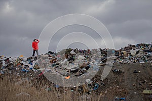 Man standing on landfill, environmental concept. Copy space.