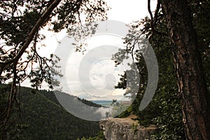 A man standing on a ledge just above the abyss