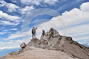 Man standing on mountain against sky