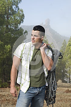 Man standing at mountain with climb equipment