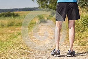 Man standing in nature before jogging