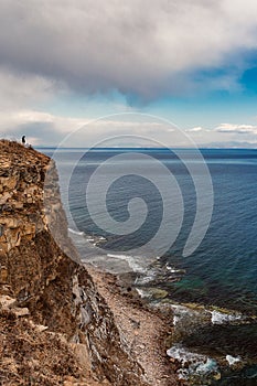 Man standing near the edge of the cliff