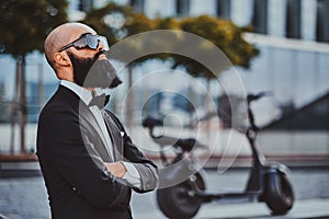 Man is standing near his electro bike