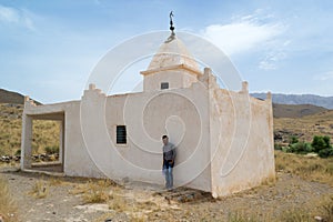 Man standing near a mausoleum in south Morocco