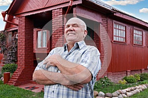 Man standing near red house