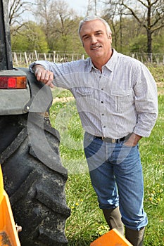 Man standing next to tractor