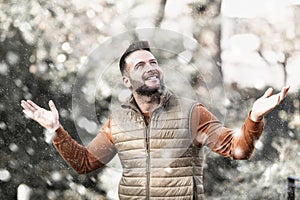 Man standing outside while falling snow