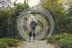 Man standing in park in fall season / autumn