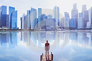 Man standing on the pier looking at modern cityscape skyline