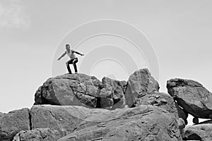 Man standing on pile of rocks -B&W- photo