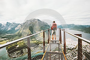 Man standing on Rampestreken viewpoint over mountains