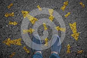 Man standing on road with many direction arrow choices or move