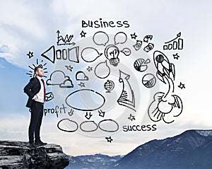 Man standing on a rock and looking at the flying business icons on the air. Mountain landscape.