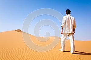 Man standing on a sand dune