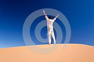 Man standing on a sand dune