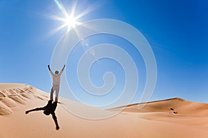 Man standing on a sand dune