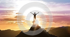 Man Standing On Top Of Mountain Looking At Daybreak Outdoors photo