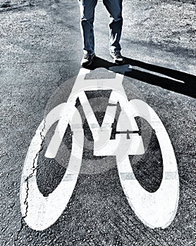 A Man Standing On Top Of A Painted Bicycle Thats Painted On The Ground