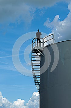 Man Standing On Top of Water Tower