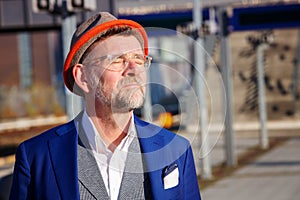 Man standing at train station and enjoying the sun