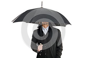 Man standing under an umbrella.