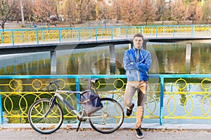 Man standing waiting with his bicycle
