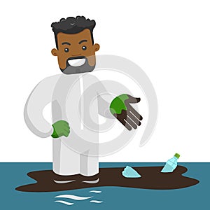 Man standing in water with oil spill and bottles.