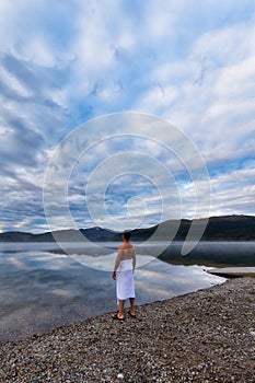 Man standing by water ready to go swimming