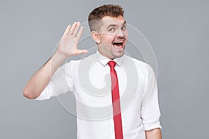 man standing wawing his hand with surprised face and greeting.