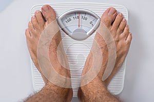 Man standing on weight scale