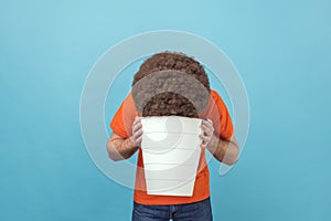 Man standing with white bucket, vomiting, suffering bad feelings, discomfort.