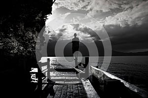 Man standing on Wooden bridge at the sea