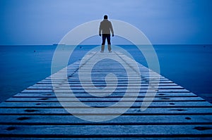 Man standing on a wooden pier