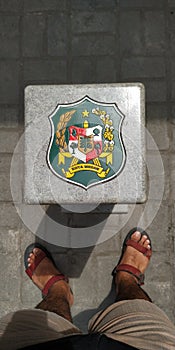 A man standing in & x22;medan city logo& x22; indonesia north sumatera goverment logo photo