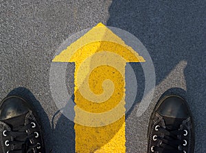 Man standing with yellow arrow move forward to future