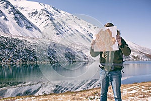 Man stands against a mountain landscape