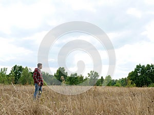 Man stands alone in an autumn field. Loneliness and travel.