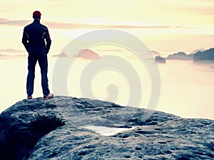 Beautiful moment the miracle of nature. Colorful mist in valley. Man hike. Person silhouette stand