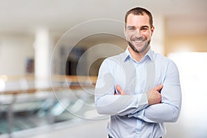 Man stands in the business center with crossed arms