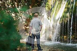 Man stands near Djur-Djur waterfall in Crimea