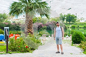 Man stands near the palm tree