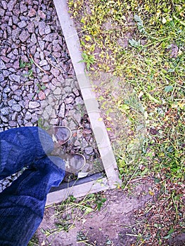 A man stands on the rubble in a fenced space.