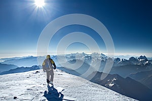 A man stands on top of Mount Elbrus