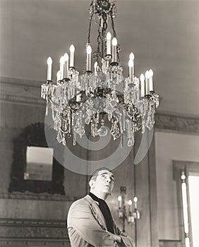 Man staring at chandelier