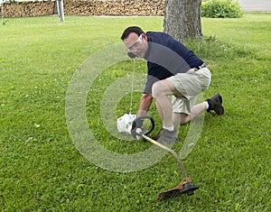 Man Starting A String Trimmer