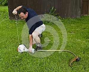 Man Starting A String Trimmer