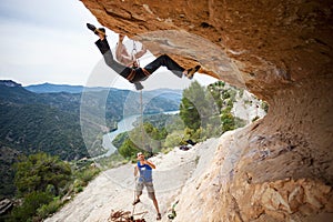 Man starting to climb challenging route photo