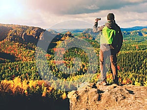 Man stay on sharp rock peak. Satisfy hiker enjoy view. Tall man on rocky cliff watching down