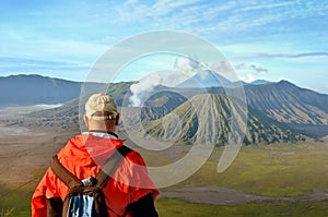 Man stay on the top near volcano Bromo in Indonesia